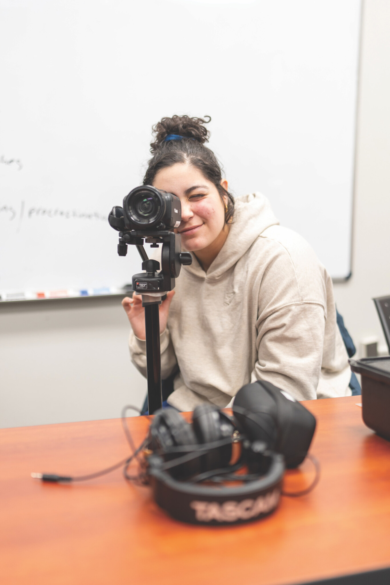 A student looking through a camera.