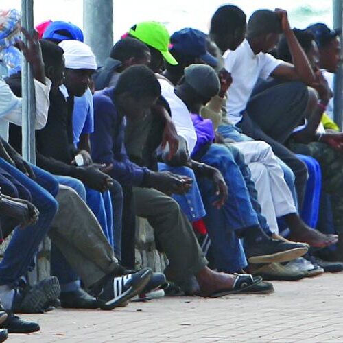 A large line of men sitting together