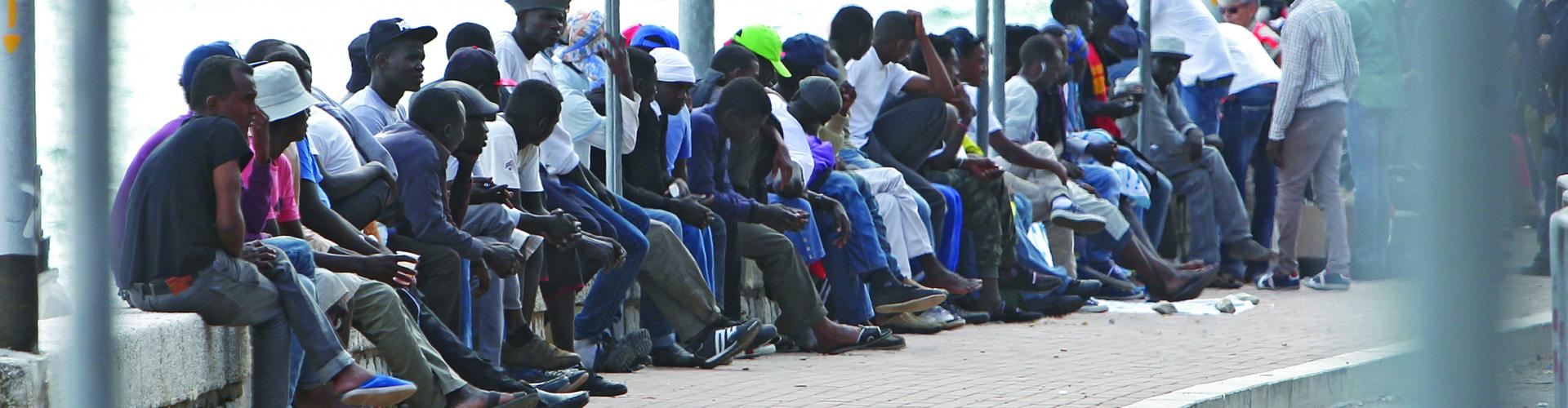 A large line of men sitting together