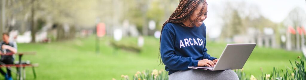 A student on her laptop on Haber Green