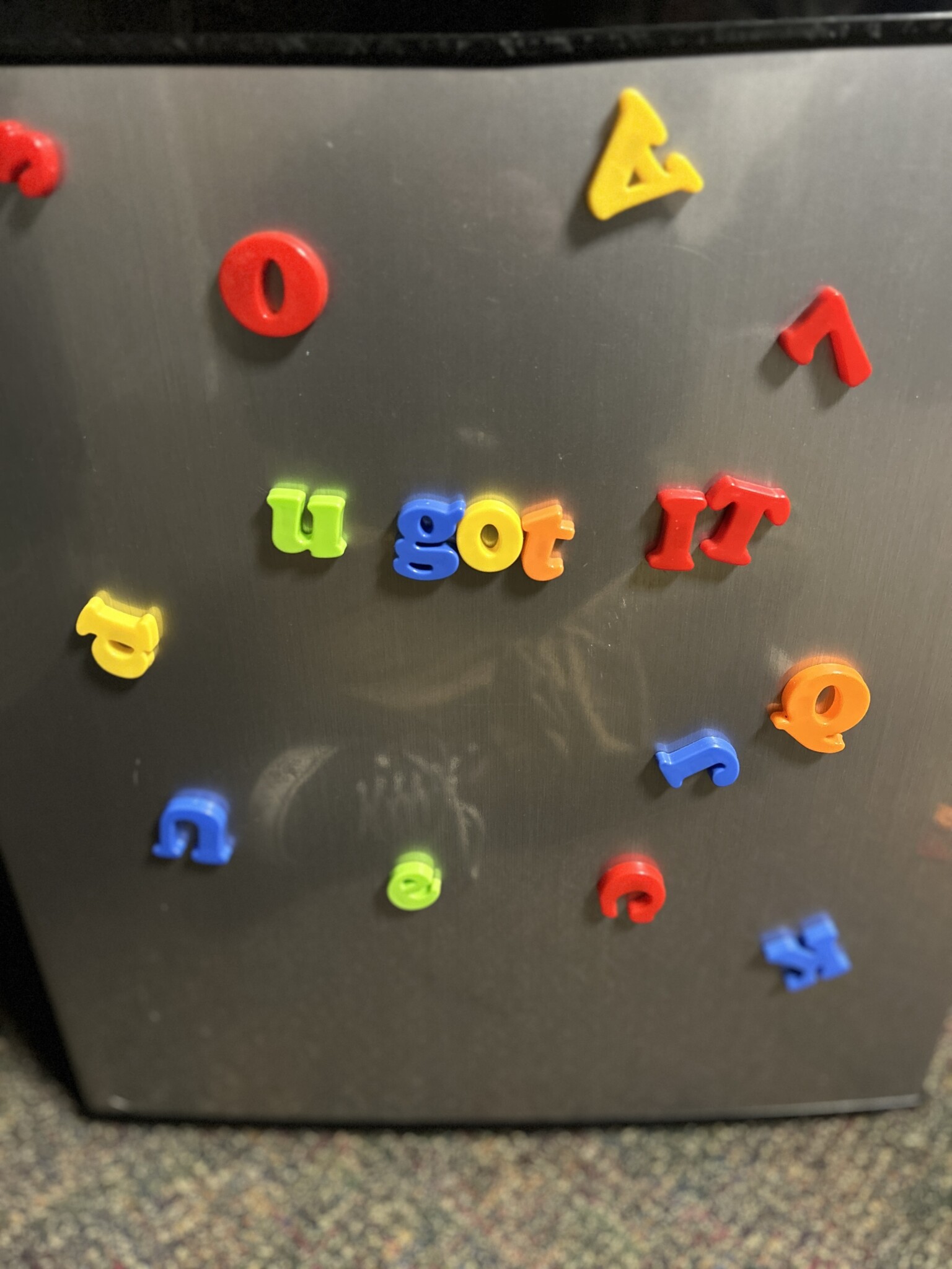 Magnetic letters spelling "U got it" on the fridge.