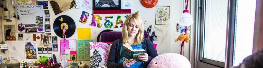 A student in her dorm reading a book