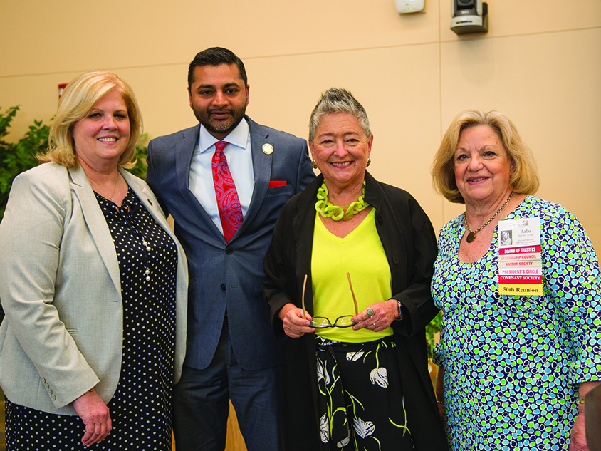 President Nair posing with students celebrating their 50th Reunion