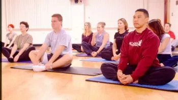 Students practicing yoga indoors