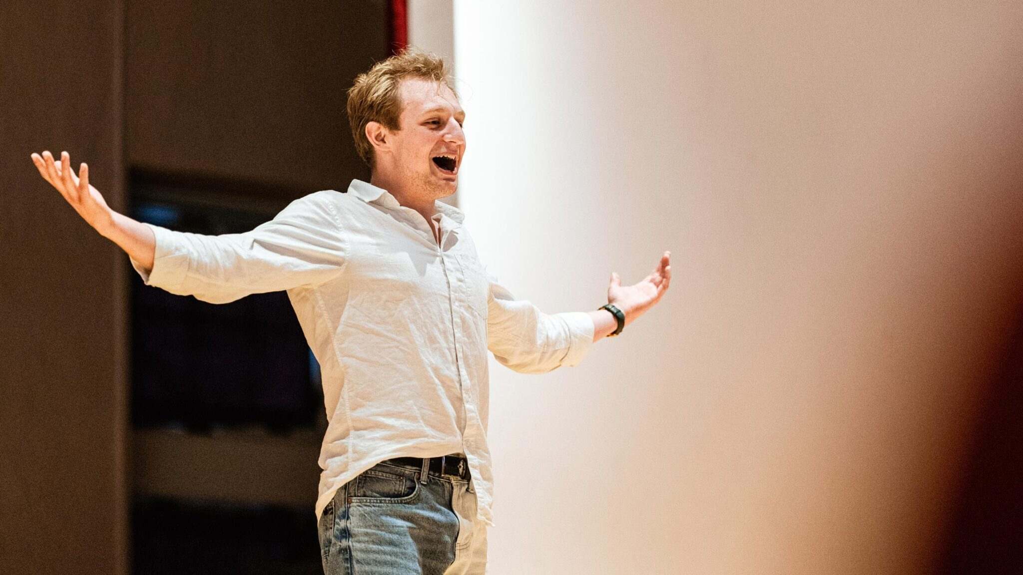 A student acts on stage in Steitler Auditorium.