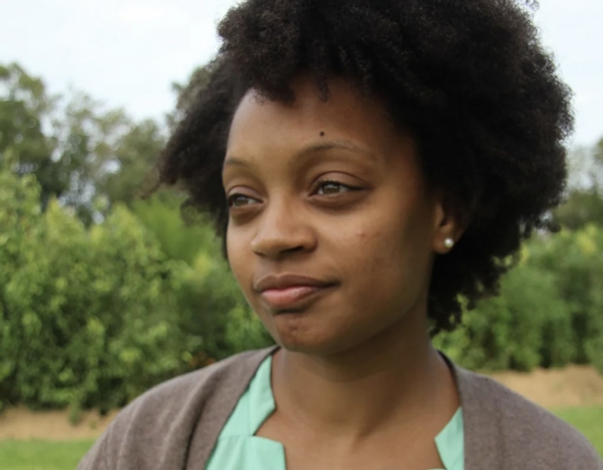 A headshot of Arcadia MFA alum Rebekah Coxwell thoughtfully looking into the distance.