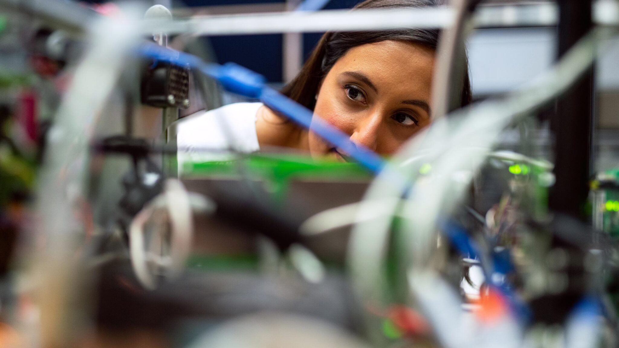 Engineering student examines wires.