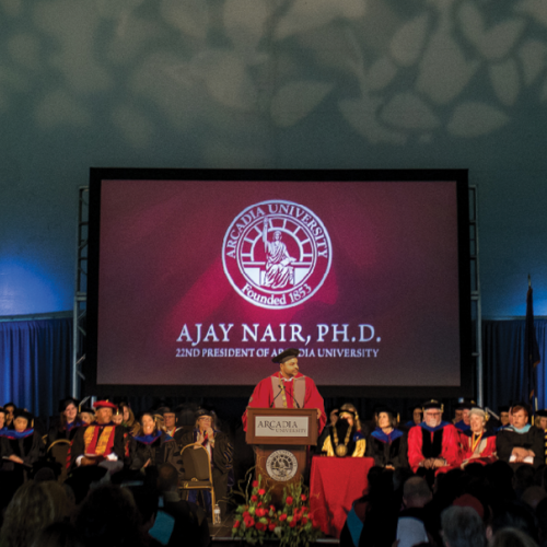 President Nair giving his inaugural address to a tent of people.