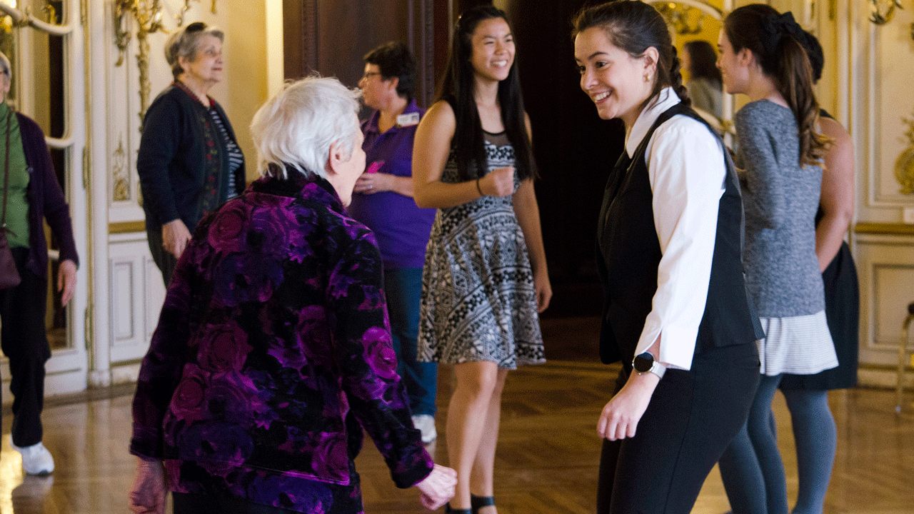 Honors students welcome seniors to a Senior Social prom event.