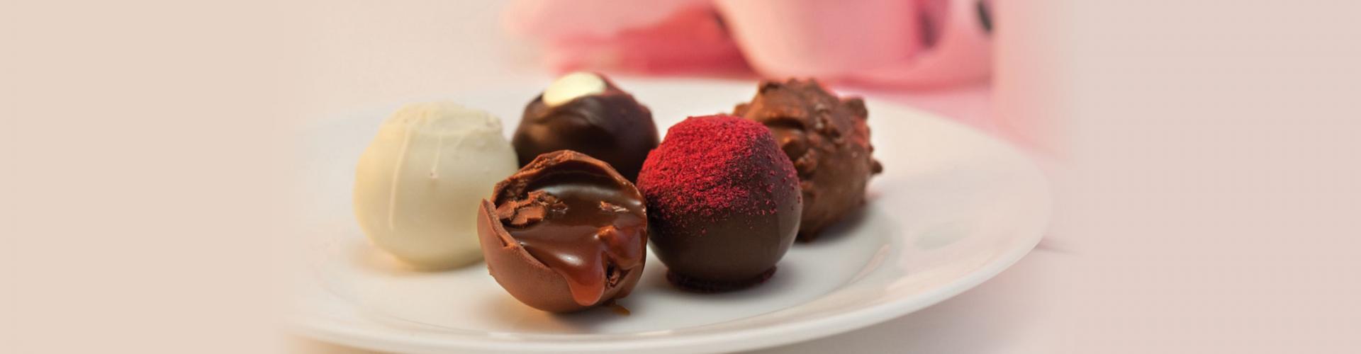 A variety of chocolate truffles served on a plate