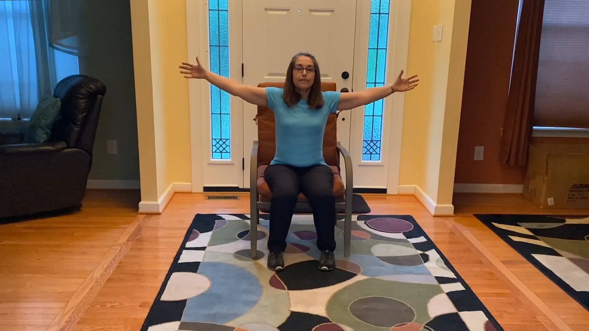 A person does an exercise in a chair