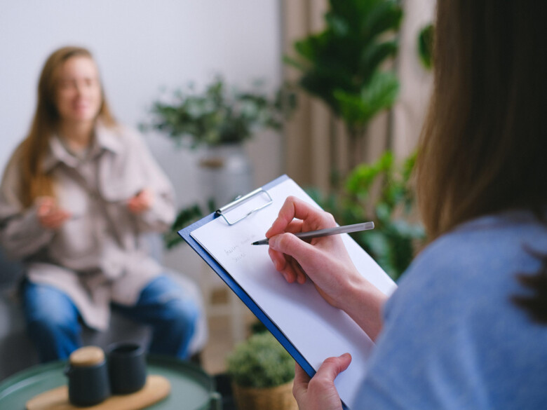 Cropped out of focus photo of person in counseling session.