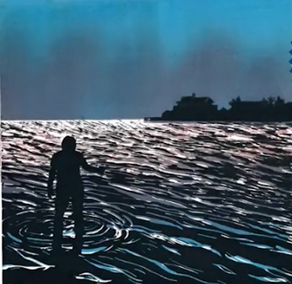 A man causing ripple effect in the water with a boat shadow in the background.