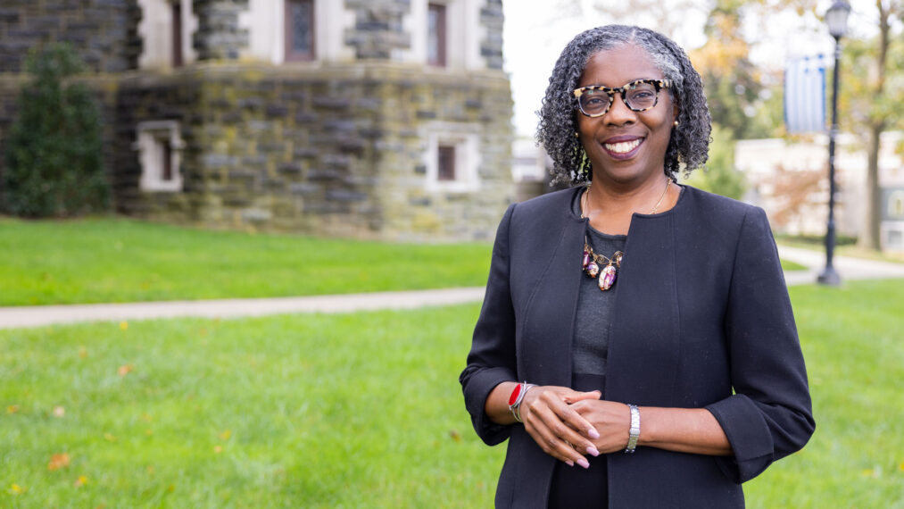 Brigette Bryant standing outside the castle while smiling at the camera.