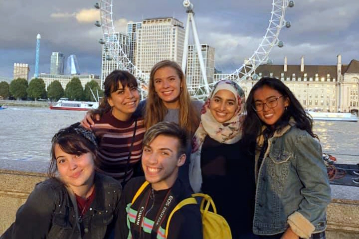 Undergraduate students enjoy touring and seeing a Ferris wheel as they study abroad.