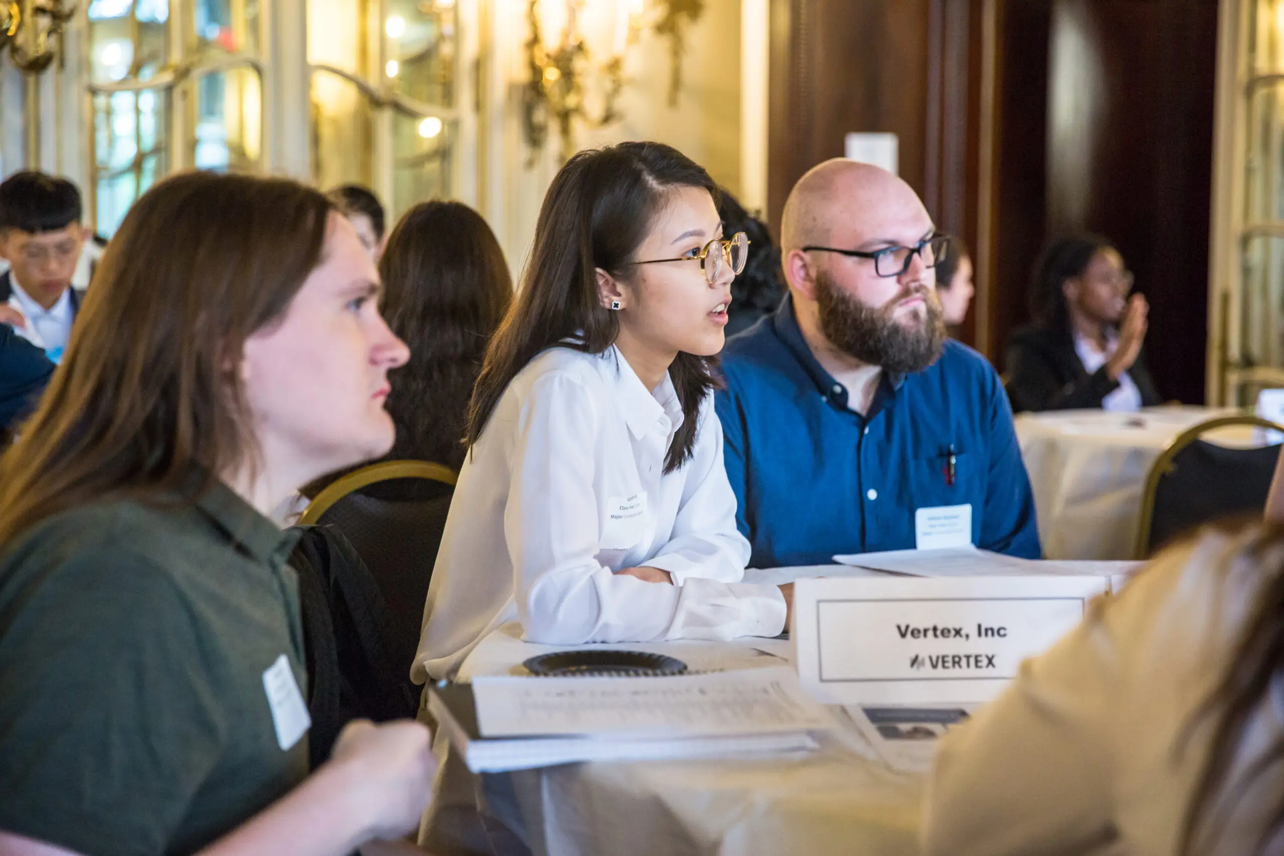 Students networking at the Vertex, Inc table at the meet-up.