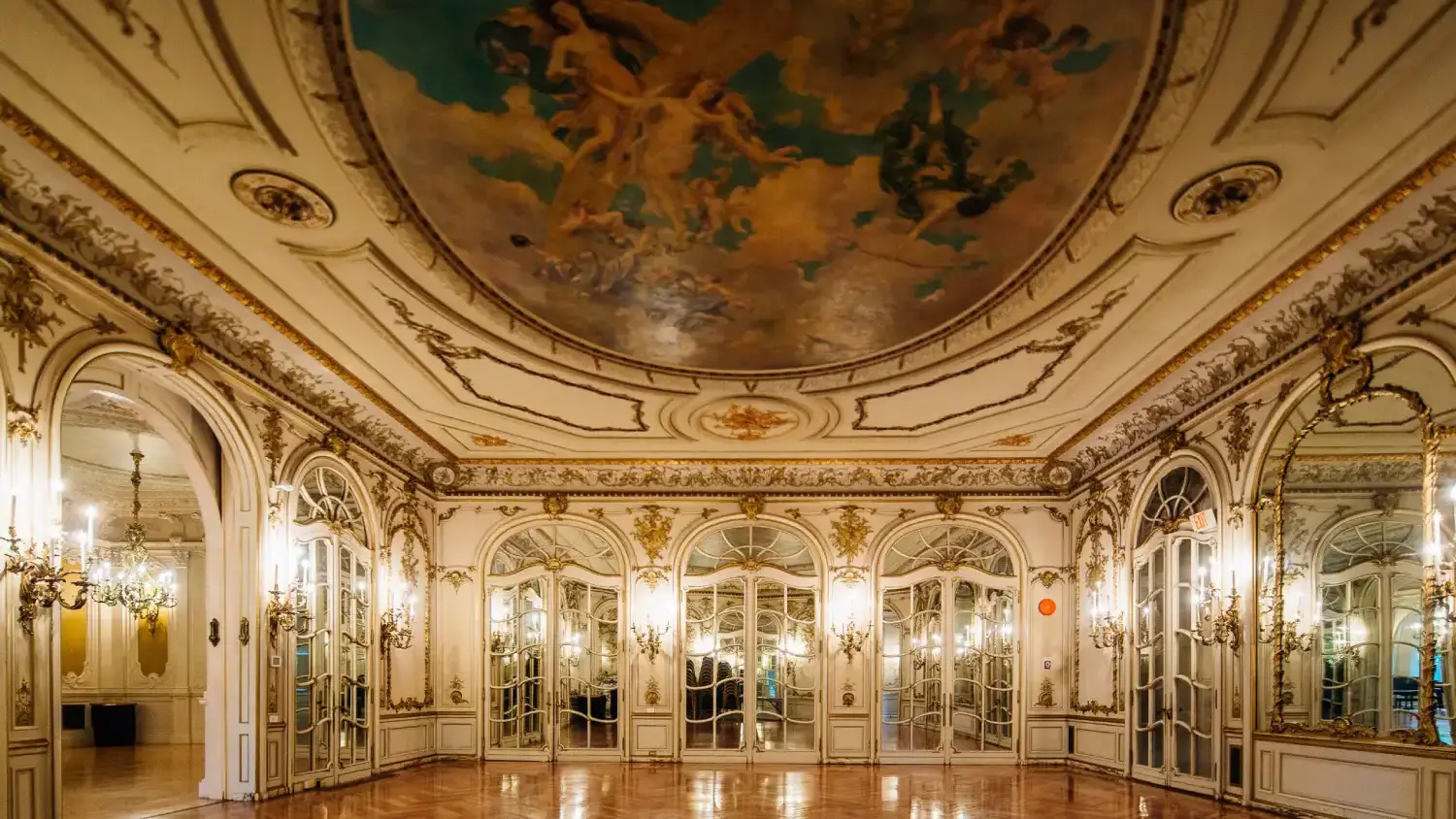 Artistic room in Greys Towers Castle with ornate mirrors on the walls and painting on ceiling