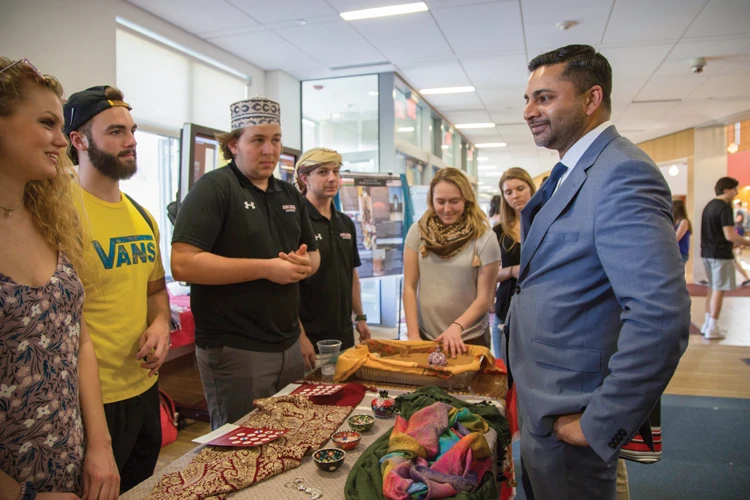 President Nair visiting Global Expo event and chatting with students.