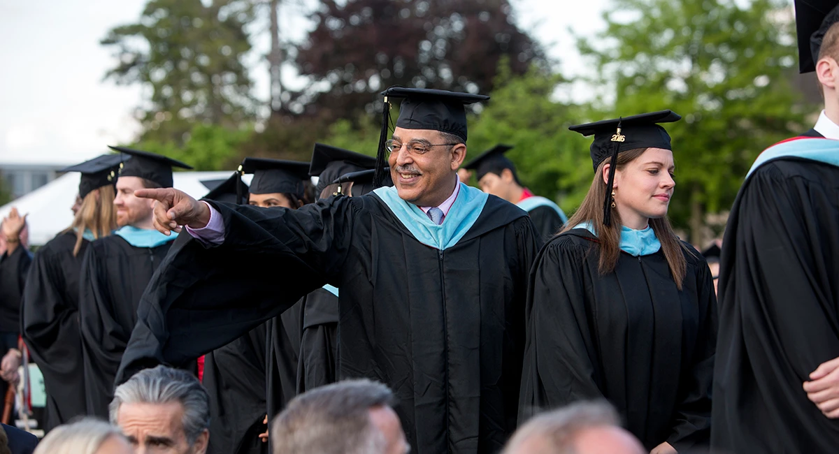 A line of graduating students walking to their ceremony.