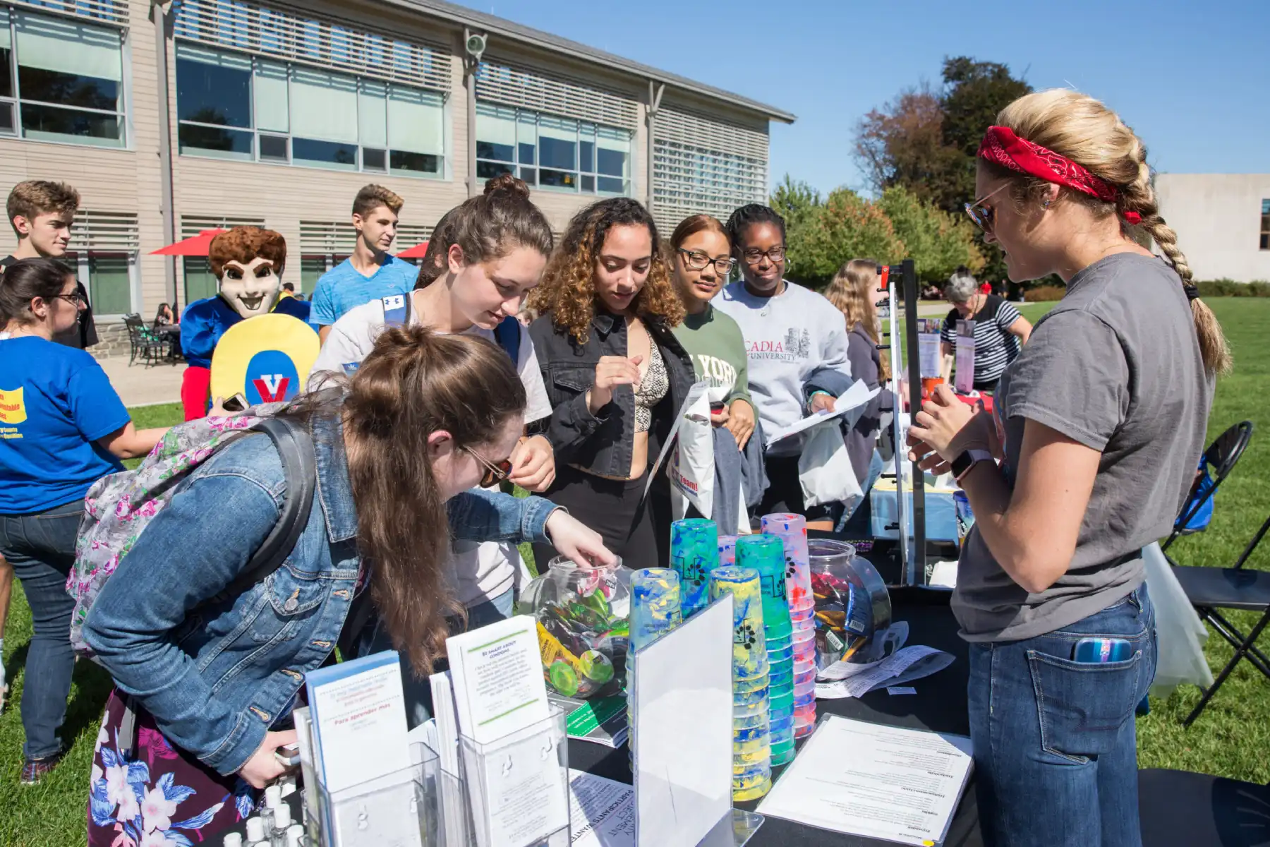 Students standing at booth at health and wellness fair on Arcadia University Campus