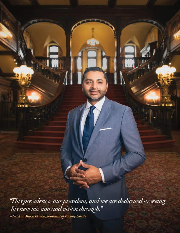 President Nair posing in front of the grand entrance staircase in Grey Towers castle.