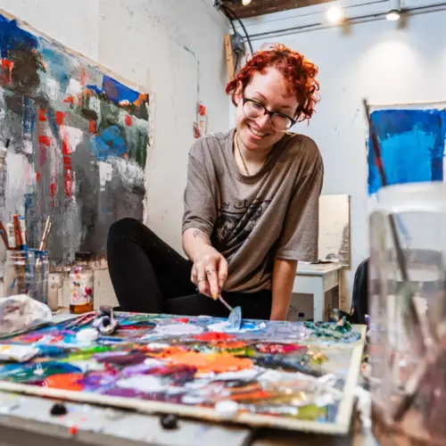 A student works with a colorful art palette.