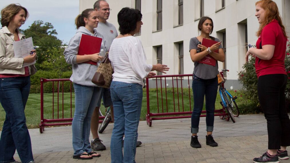 Students, parents, and campus tour guide standing in group during an Arcadia University campus tour.