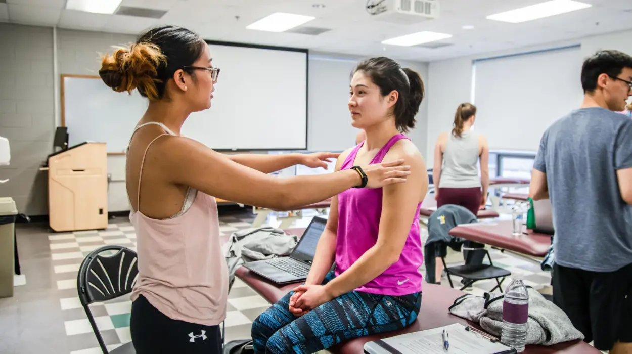 A physical therapy student conducts an exam on a patient.