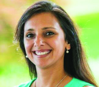 Maya Basu Johnson smiling and looking towards the camera.
