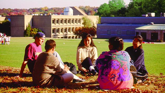 A photo taken of students on the lawn on campus in 1994 adjusted for differences visible in 2019.