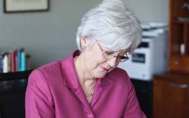 Susan Savage graduate of Arcadia working in her office.