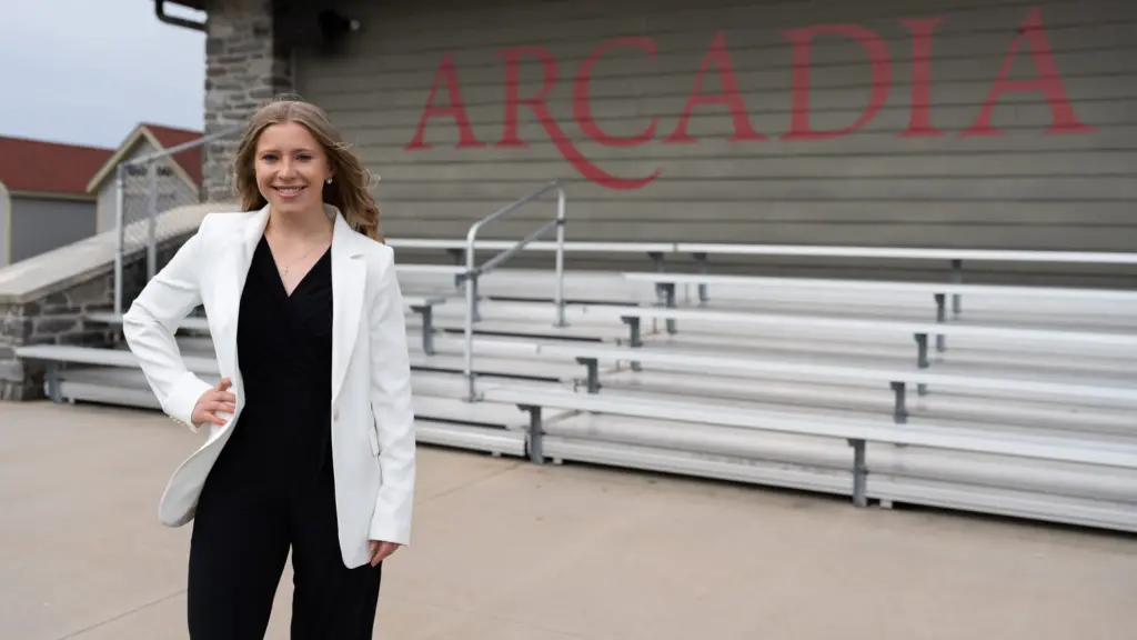 Caroline Weirich headshot in front of Arcadia bleachers.