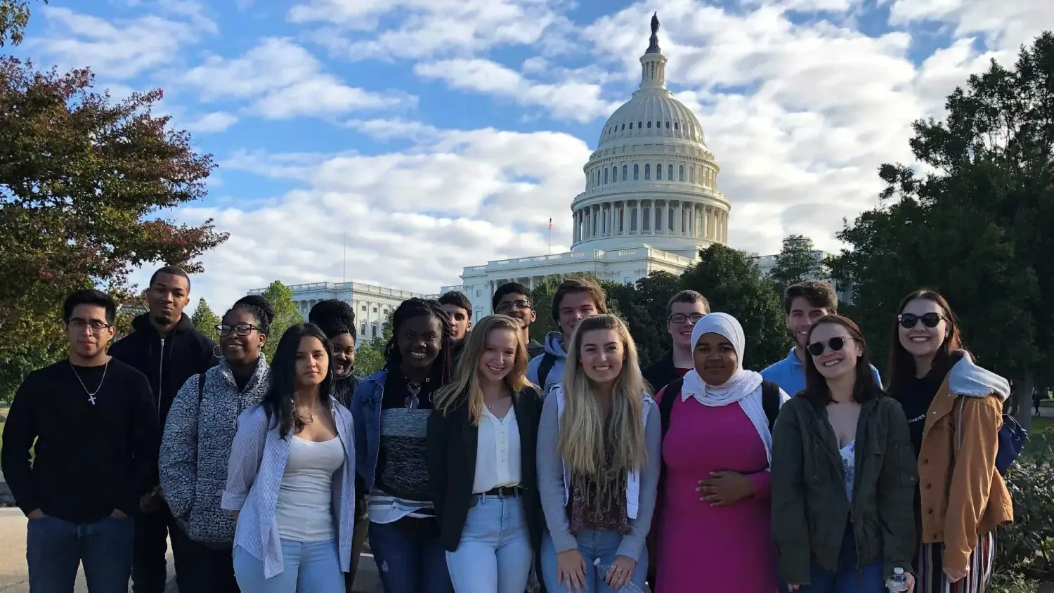 Group of students smile and look at the camera.