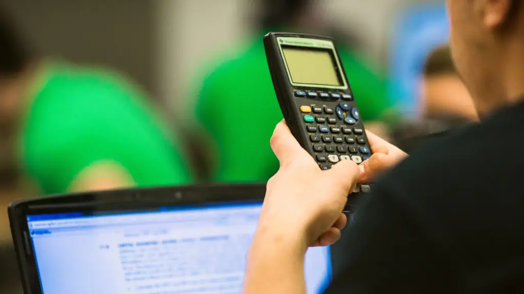 Close up photo of a student holding a calculator.