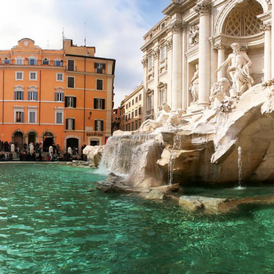 A fountain of emerald-blue water and classic statues in Perugia, Italy.