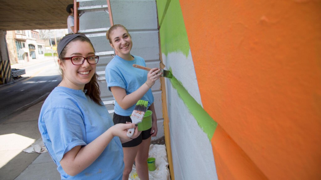 Students paint a mural.