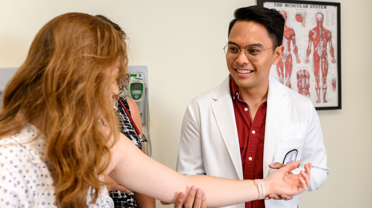 Physician assistant student examines a patient.