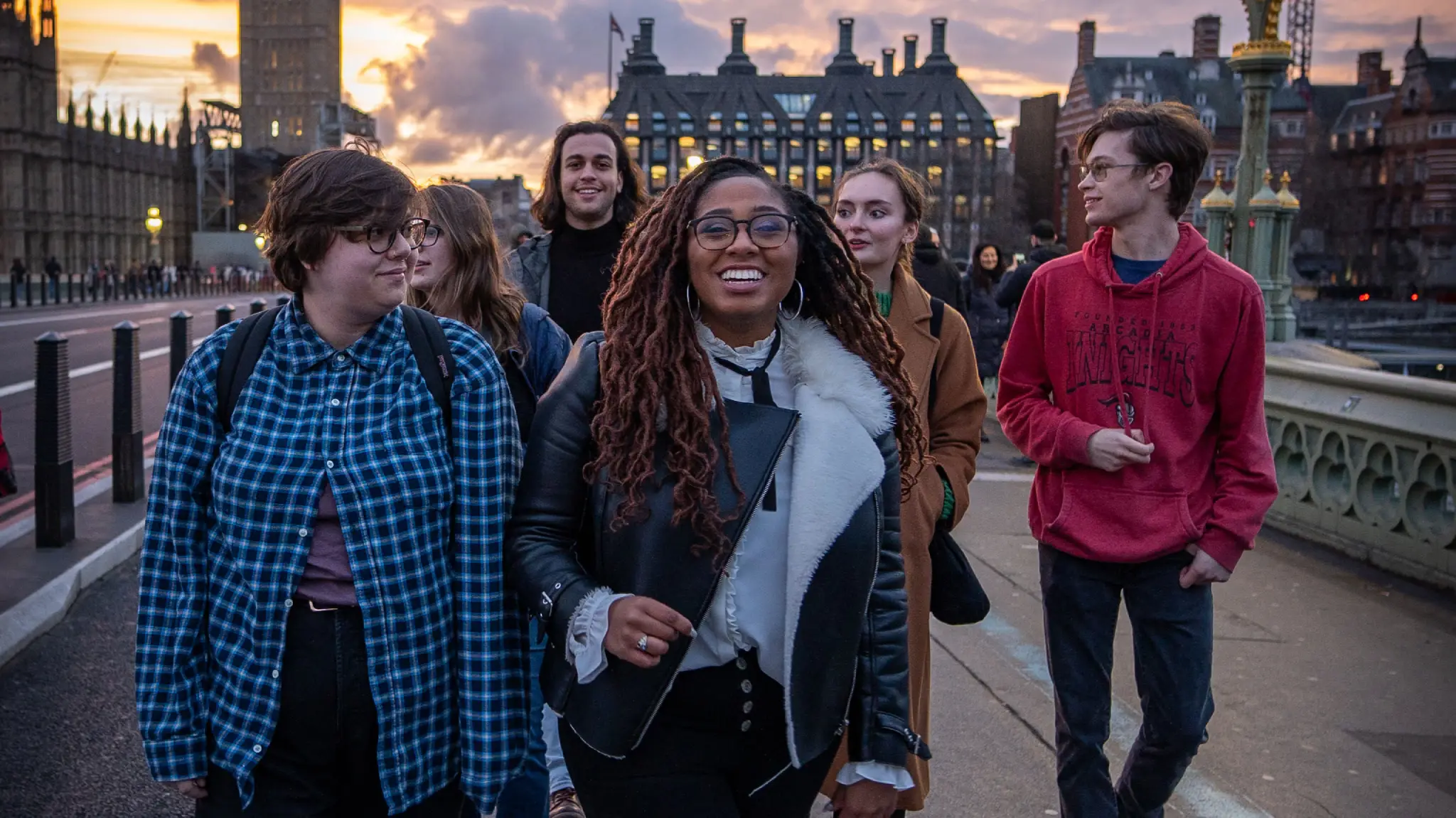 Arcadia students visit a European city and walk over a bridge.