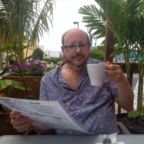 Dr. Appelbaum seated at an outdoor cafe in Greece