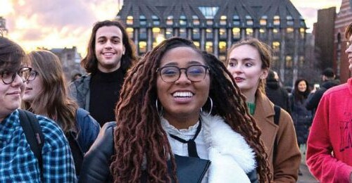 A group of students in London walking down a city street