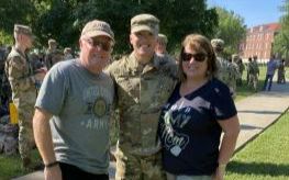 Dean with his father, Dean Cahill Sr., and mother, Maureen Cahill, posing outdoors at U.S. Army Cadet Command Advanced Camp graduation in Fort Knox, Kentucky.