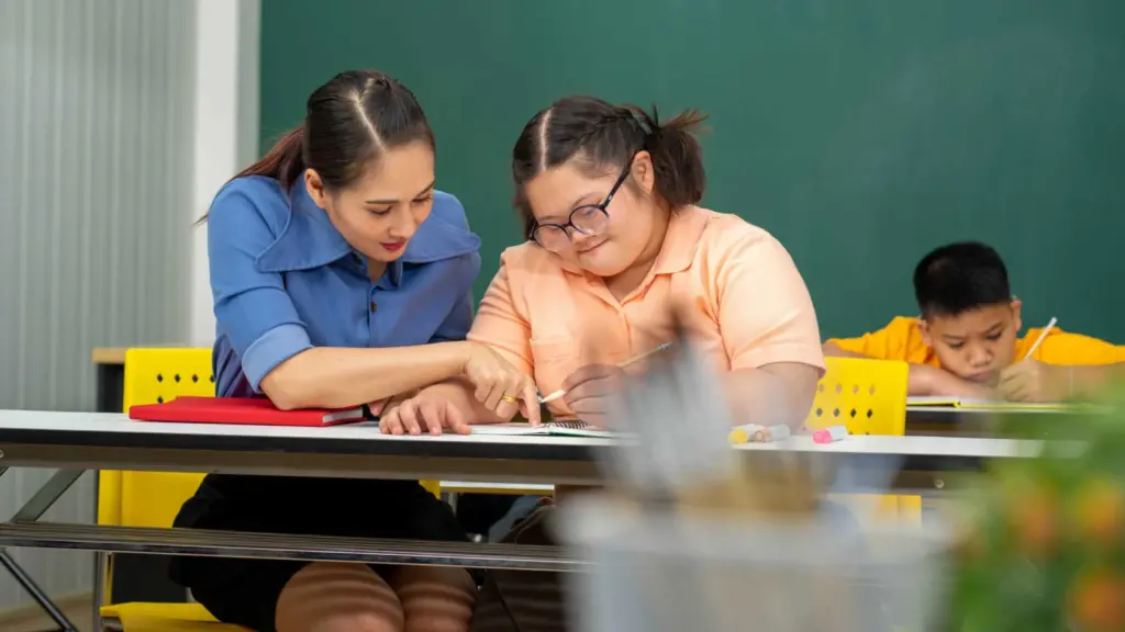 A teacher helping a student write