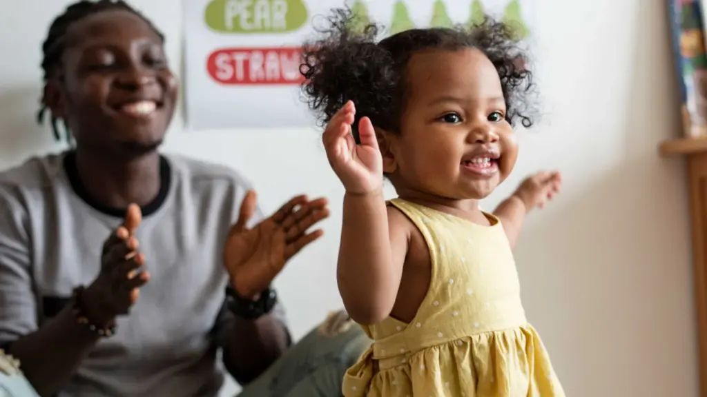 A man teaching a baby to walk