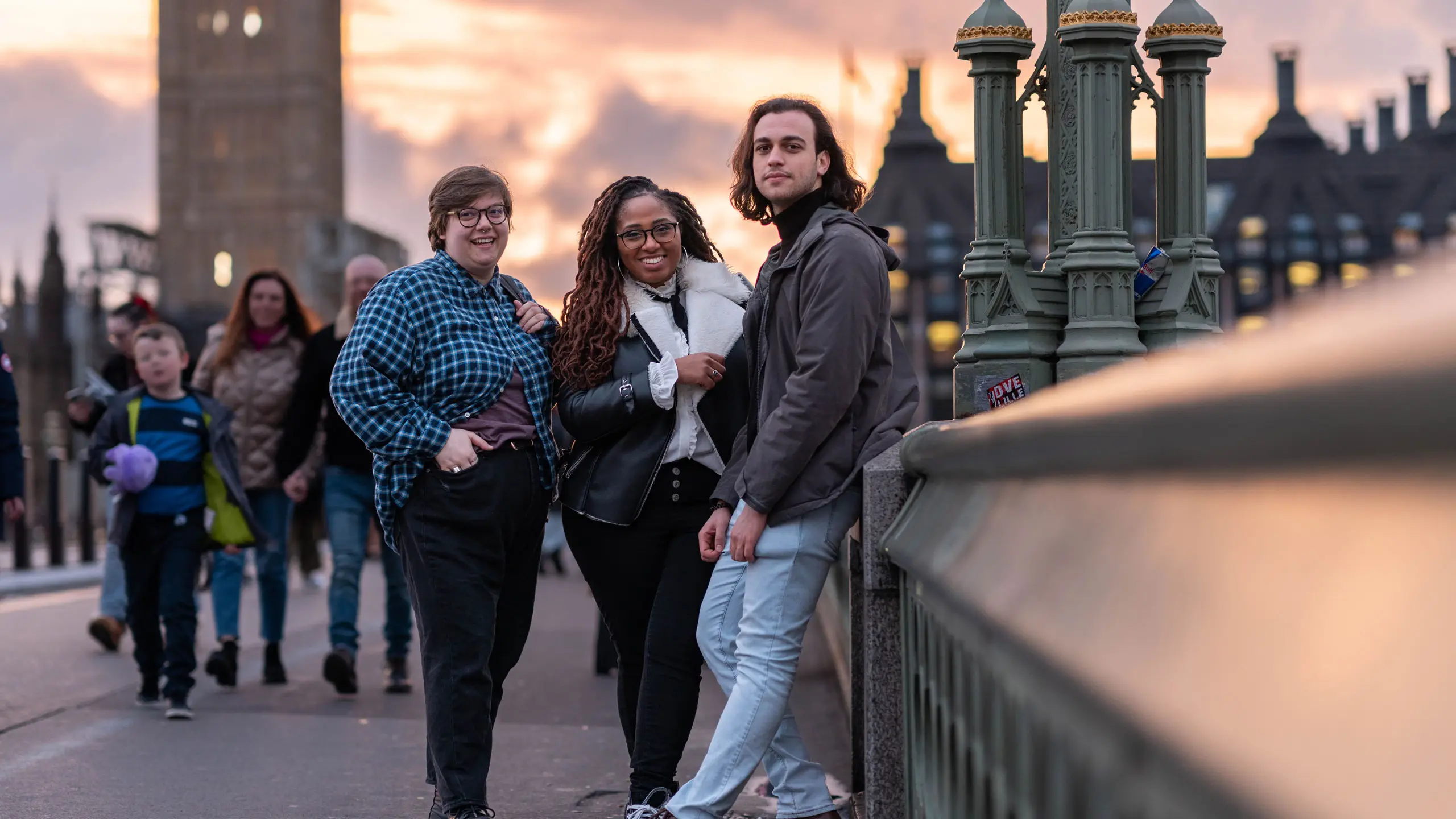 Students studying abroad pose on London bridge.