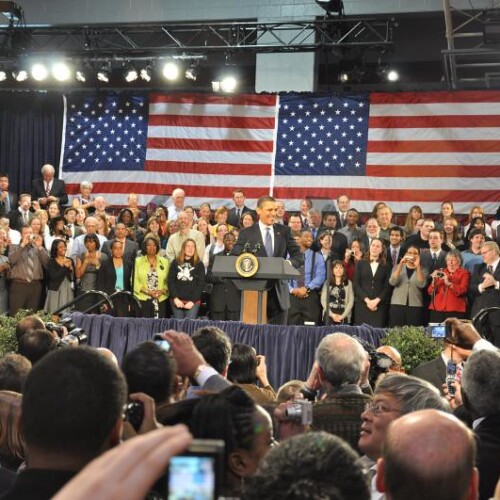 Barack Obama standing at a podium for a press conference