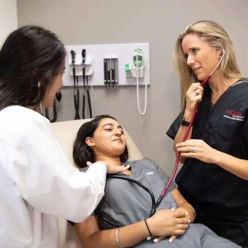 A group of students in the Physician Assistant program care for a patient