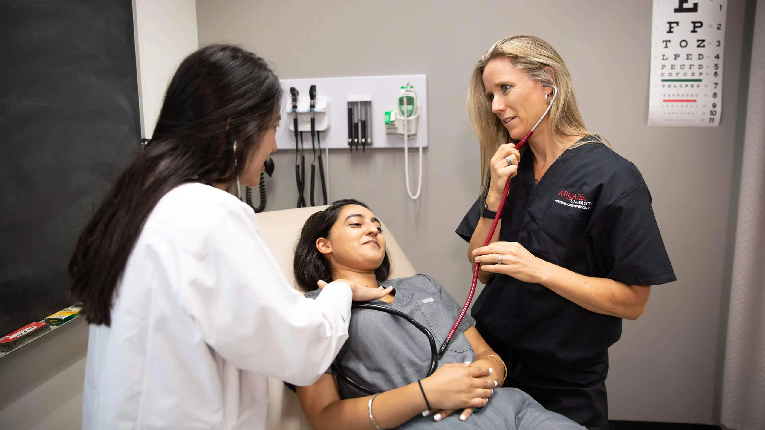 A group of students in the Physician Assistant program care for a patient