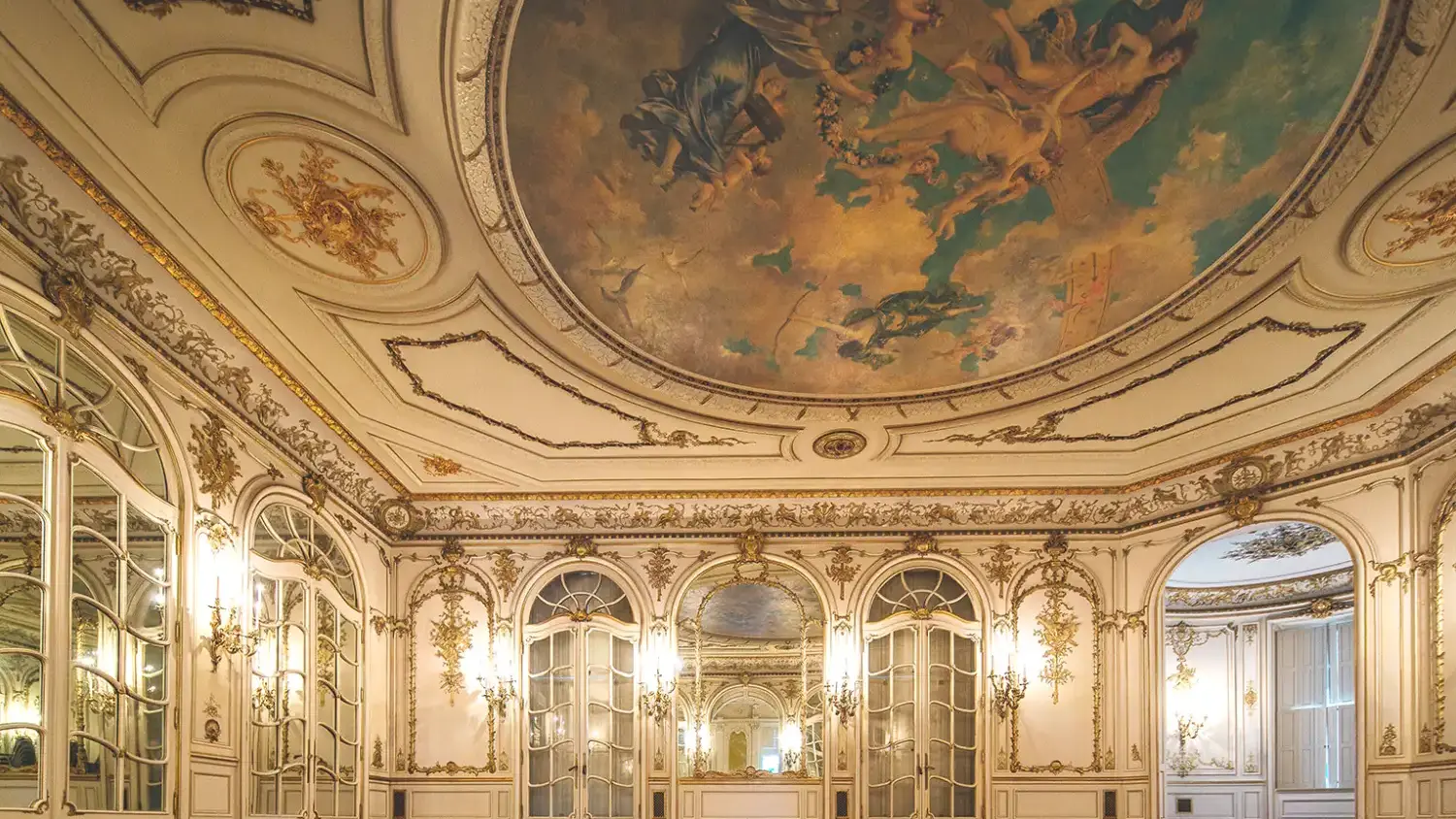 Artistic room in Greys Towers Castle with ornate mirrors on the walls and painting on ceiling