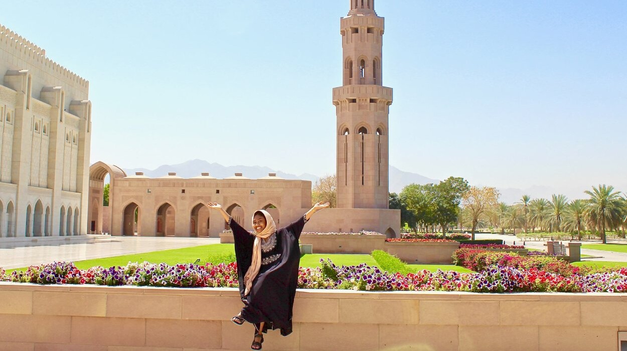 An Arcadia students sits in a flower and palm tree garden in a mosque overseas as she studies aborad.