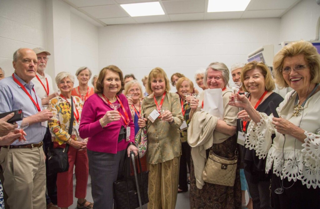 Senior alumni group raising their glasses in a toast.